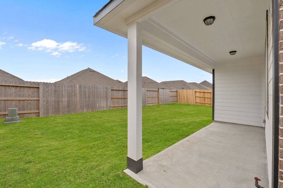 The covered patio is perfect for an outdoor living space, bbq pit and more.