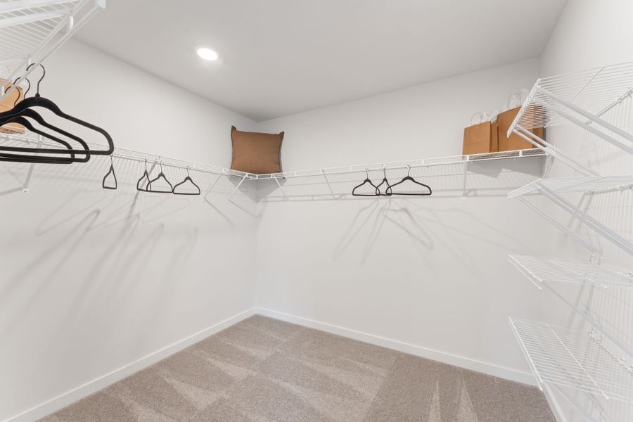 A white bed with a white bed frame. A white bed with a white bed frame.