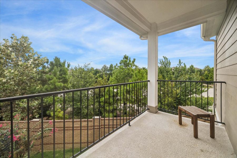 Enjoy the covered balcony just off the second-floor game room, with views of mature trees for a peaceful outdoor retreat.