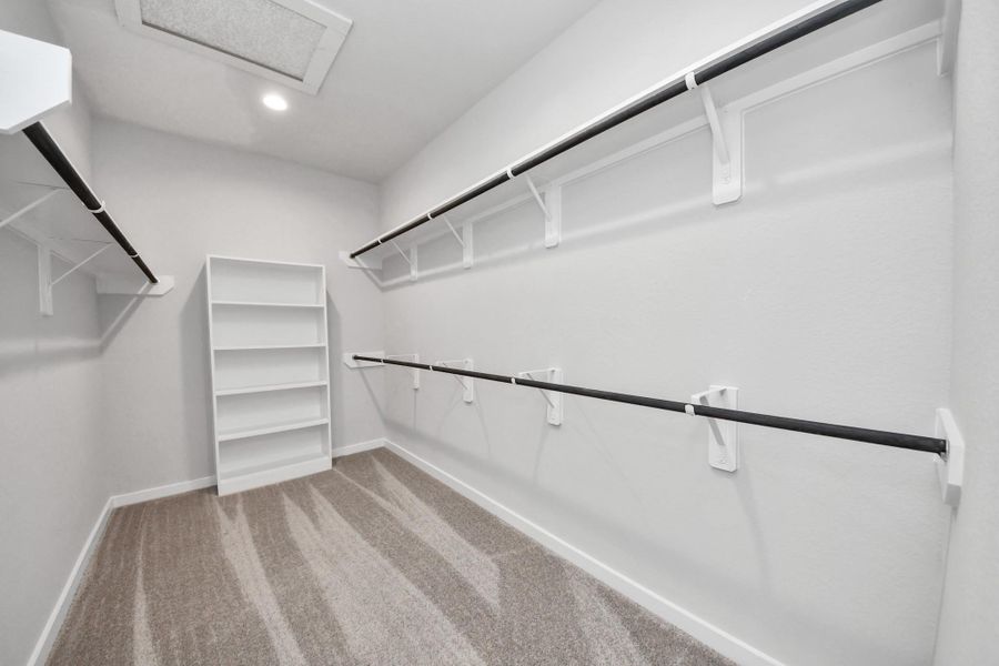 Walk-in closet that epitomizes luxury and practicality. This generously sized space features built-in shelving, offering abundant room for impeccable organization. High ceilings and recessed lighting create a bright and welcoming ambiance. Walk-in closet that epitomizes luxury and practicality. This generously sized space features built-in shelving, offering abundant room for impeccable organization. High ceilings and recessed lighting create a bright and welcoming ambiance.