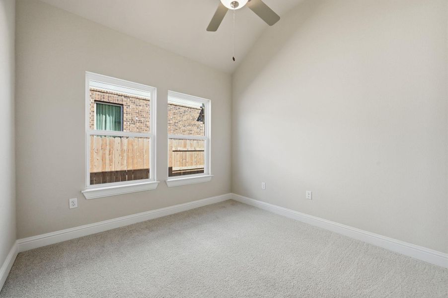 Unfurnished room featuring lofted ceiling, carpet floors, and ceiling fan Unfurnished room featuring lofted ceiling, carpet floors, and ceiling fan