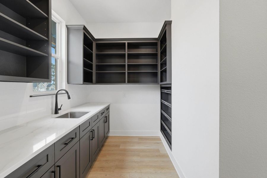 Functional butler’s pantry offering additional storage and prep space, ideal for entertaining and organization.