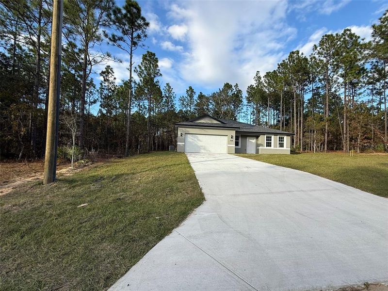 Front exterior of a new home in , Citrus Springs, FL, highlighting curb appeal (Image 31).