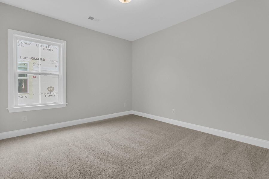 Spacious, unfurnished interior of a new home in Tidewater at Lakes of Cane Bay, Summerville (Image 18).