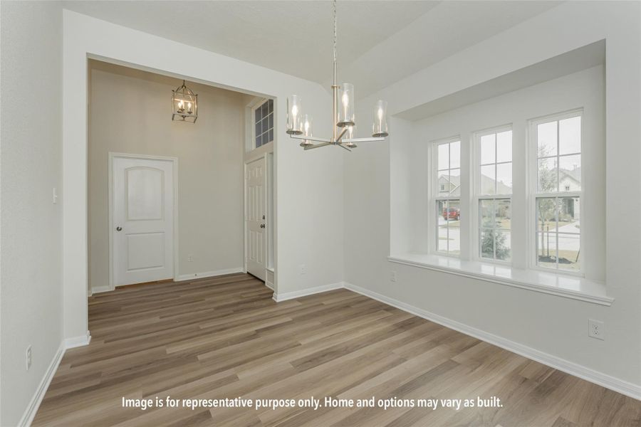 Unfurnished dining area with light wood-style floors and a chandelier