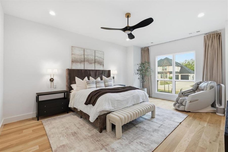 Bedroom featuring a ceiling fan, light wood-style floors, and recessed lighting