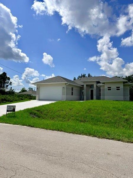 Front exterior of a new home in , Lehigh Acres, FL, highlighting curb appeal (Image 19).