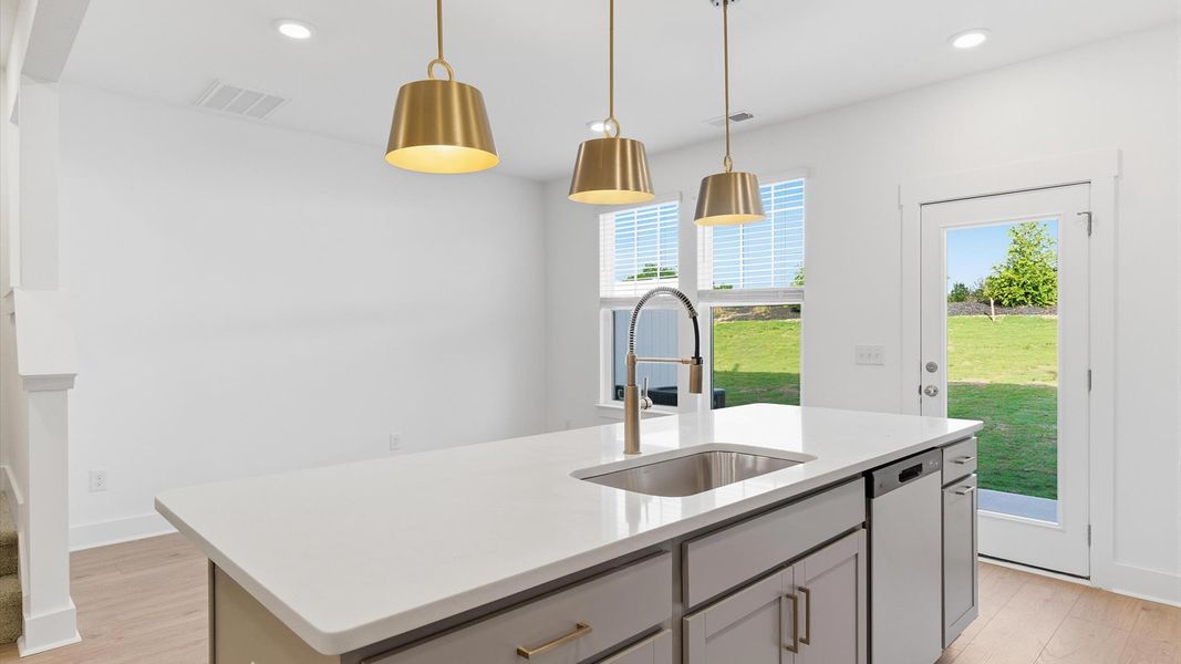 Superior kitchen with quartz countertops, pendant lighting, and a generously sized island at Anderson, SC