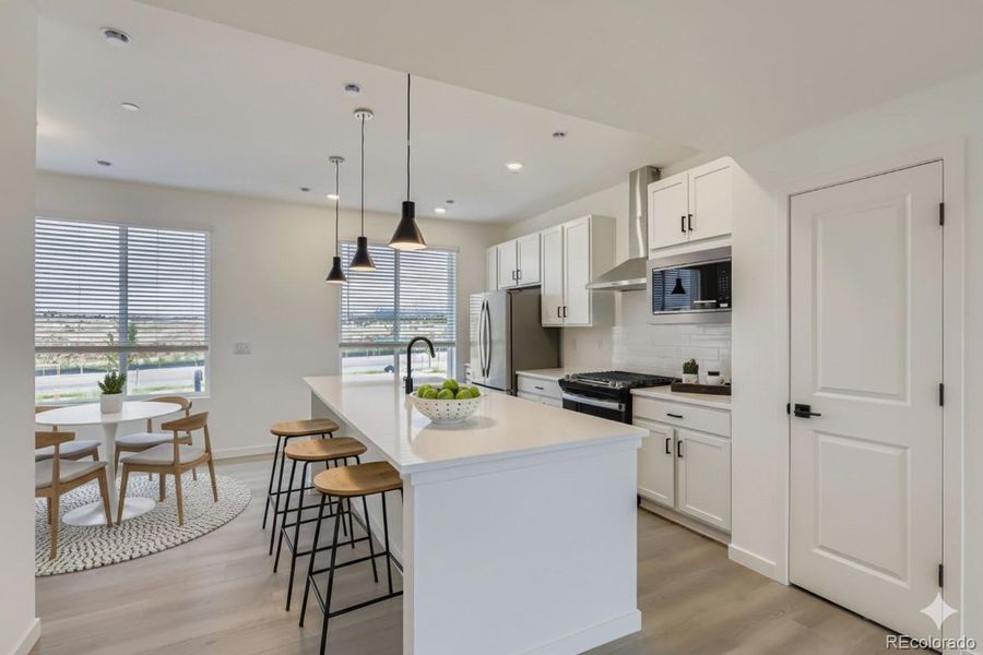 Kitchen and dining space. Staged
