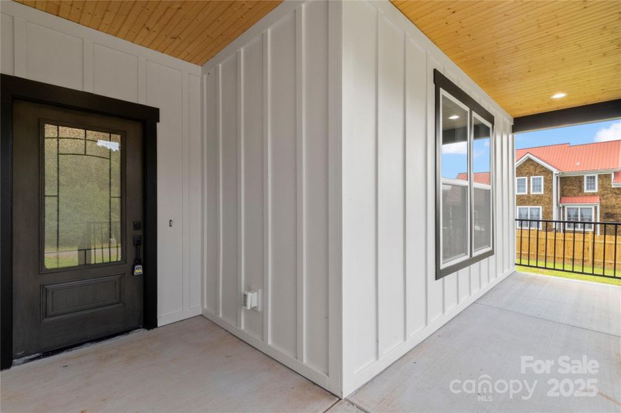 Gorgeous front porch with wood ceiling