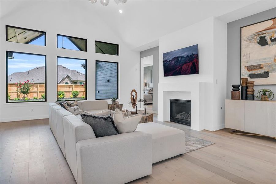 Family room with a vaulted ceiling, plus a direct vent fireplace and a cast stone surround.