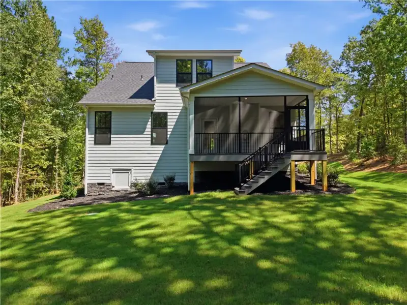 A spacious green lawn surrounds this contemporary