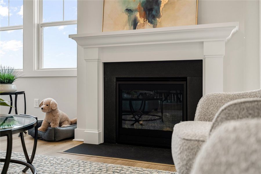 A striking fireplace with a dark surround anchors A striking fireplace with a dark surround anchors