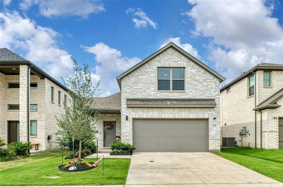 View of front of home featuring brick siding, a front lawn, roof with shingles, concrete driveway, and a garage View of front of home featuring brick siding, a front lawn, roof with shingles, concrete driveway, and a garage