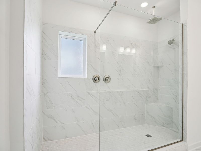 The primary bathroom offers dual vanity sinks and a walk-in shower. The primary bathroom offers dual vanity sinks and a walk-in shower.