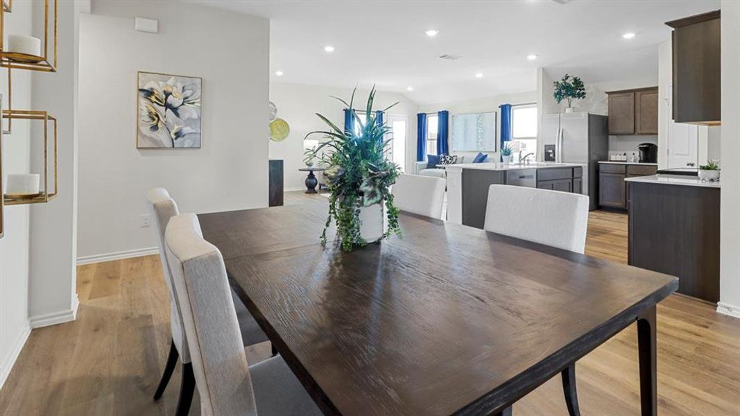 Dining room featuring recessed lighting, light wood finished floors, and vaulted ceiling