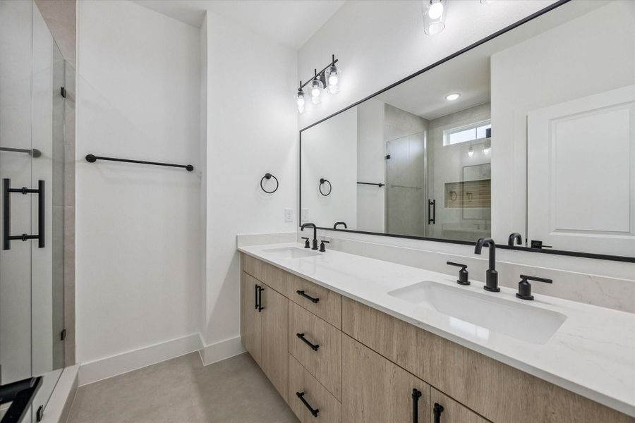 Full bath with extended vanity, glass shower, and polished finishes Full bath with extended vanity, glass shower, and polished finishes