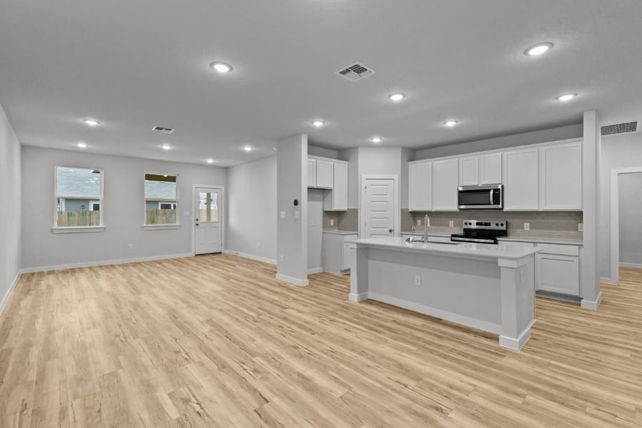 A large kitchen with white cabinets. A large kitchen with white cabinets.
