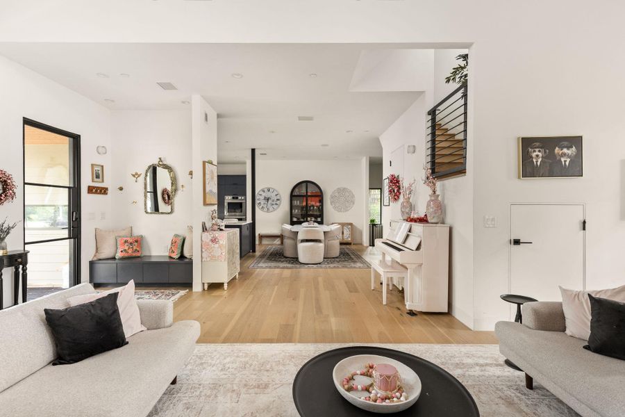 An inviting open-concept layout unfolds with light wood flooring connecting the living and dining areas. An inviting open-concept layout unfolds with light wood flooring connecting the living and dining areas.