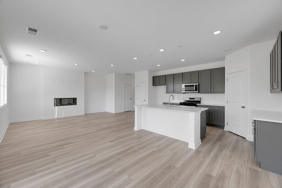 A large kitchen with white cabinets.