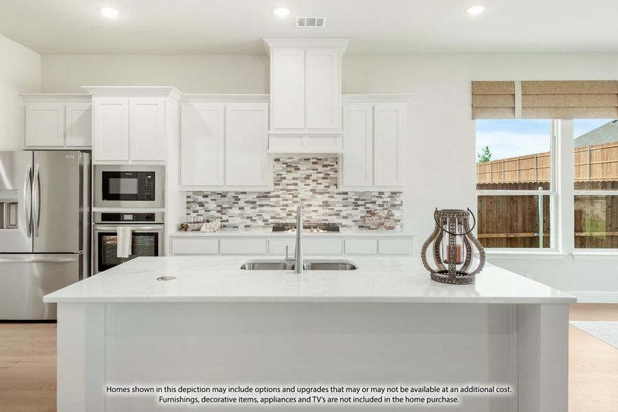 Kitchen with white cabinets, tile backsplash, center island with sink, and stainless steel appliances Kitchen with white cabinets, tile backsplash, center island with sink, and stainless steel appliances