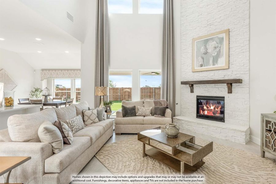 Living room with vaulted ceiling, white stone fireplace, and two beige sofas facing a wood coffee table