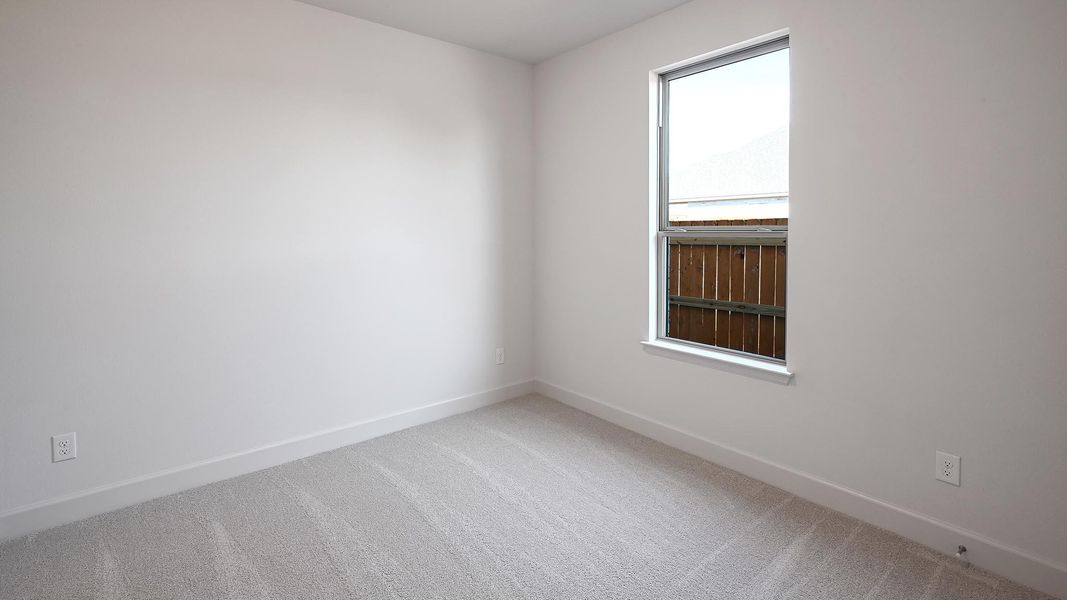 Carpeted empty room featuring baseboards Carpeted empty room featuring baseboards