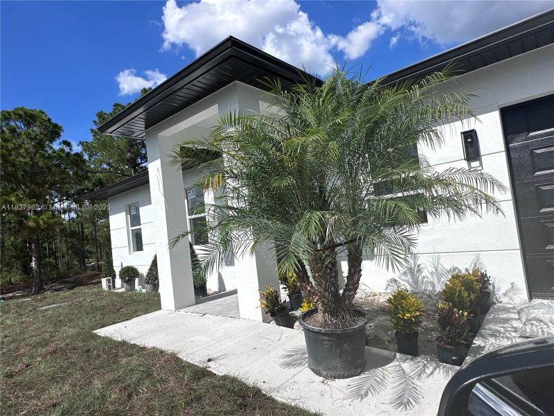 Front exterior of a new home in , Lehigh Acres, FL, highlighting curb appeal (Image 1). Front exterior of a new home in , Lehigh Acres, FL, highlighting curb appeal (Image 1).