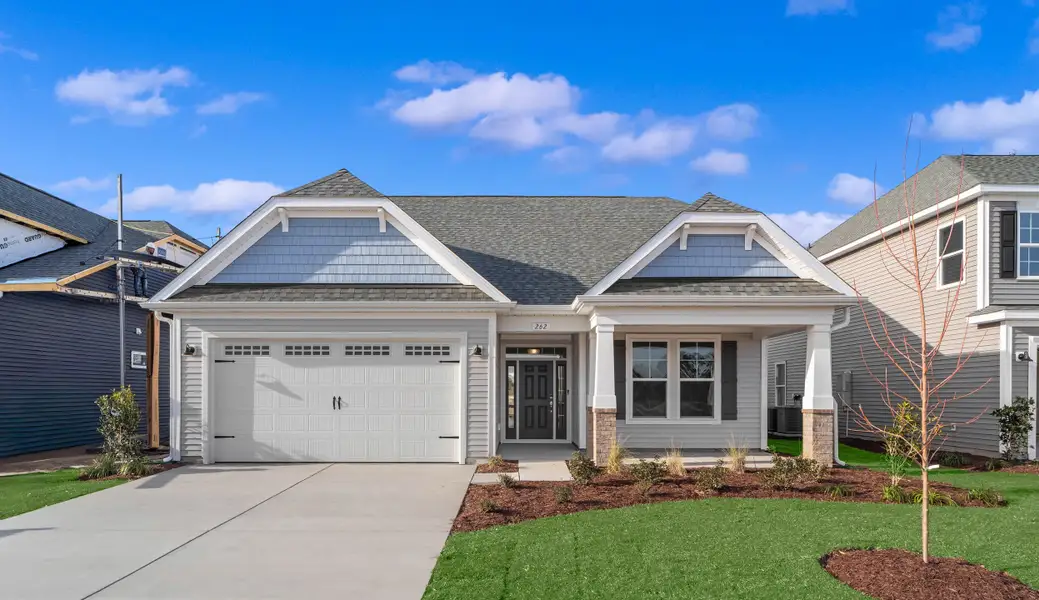 Front exterior of a new home in Traditions at Carolina Forest, Myrtle Beach, SC, highlighting curb appeal (Image 16). Front exterior of a new home in Traditions at Carolina Forest, Myrtle Beach, SC, highlighting curb appeal (Image 16).