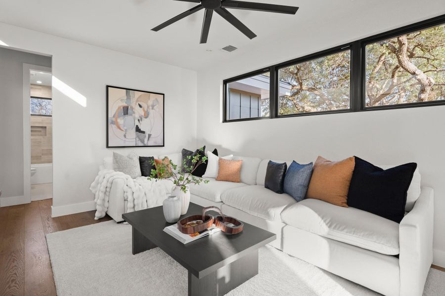 Living room featuring wood finished floors and ceiling fan