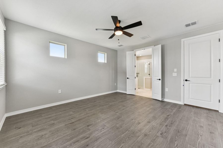 Unfurnished bedroom with light wood finished floors and ceiling fan Unfurnished bedroom with light wood finished floors and ceiling fan