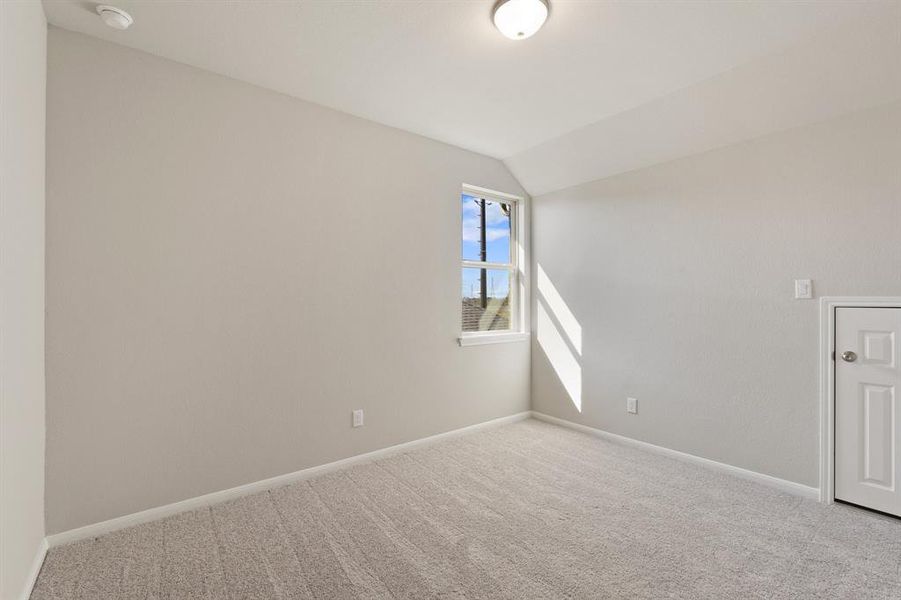 Your secondary bedroom features plush carpet, fresh paint, closet, and a large window that lets in plenty of natural lighting.