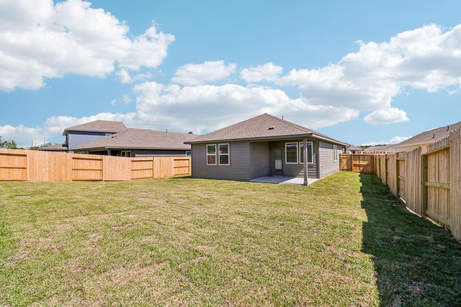 Exterior details and patio area of a home in Granger Pointe - Traditional Series, New Caney (Image 26).