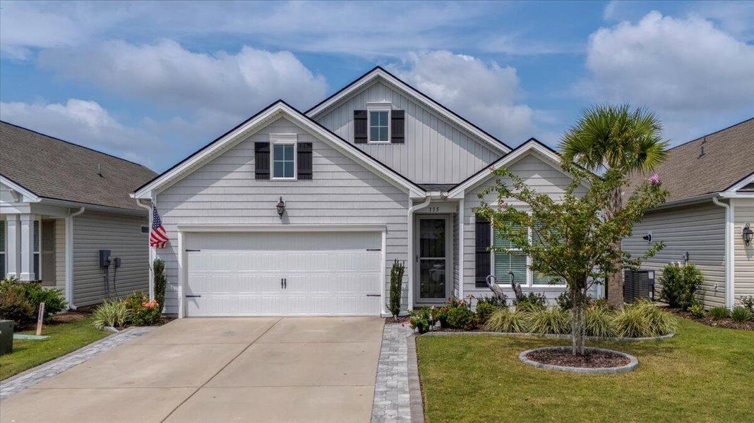 Front exterior of a new home in K. Hovnanian's® Four Seasons at Lakes of Cane Bay, Summerville, SC, highlighting curb appeal (Image 24).