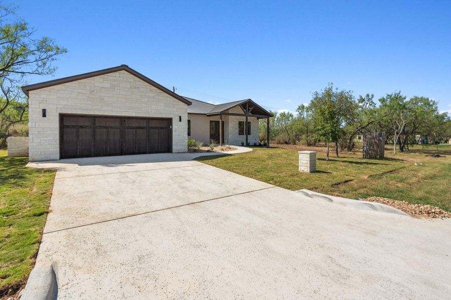 Front exterior of a new home in , Horseshoe Bay, TX, highlighting curb appeal (Image 23). Front exterior of a new home in , Horseshoe Bay, TX, highlighting curb appeal (Image 23).