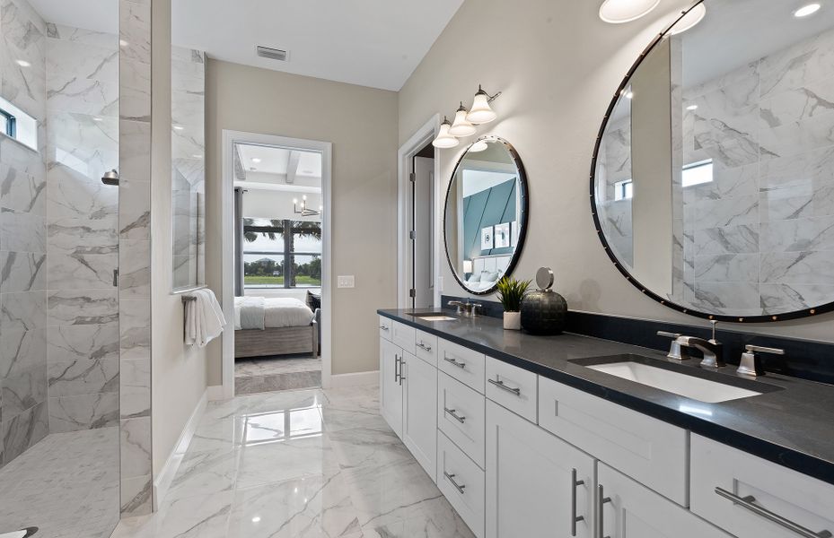 Owner's bathroom with walk-in shower and double sink vanity
