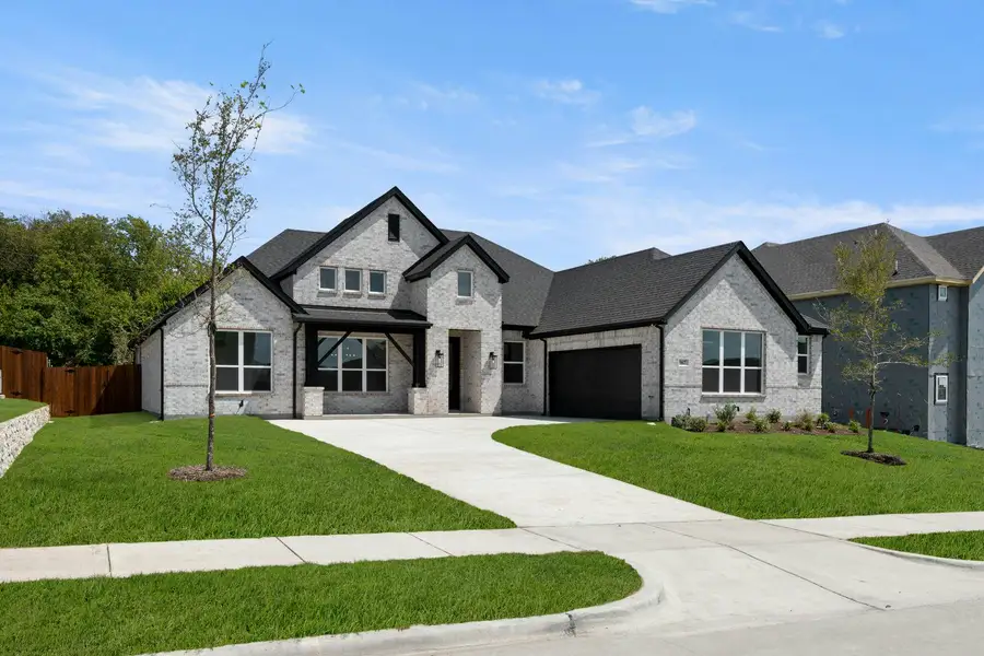 Front exterior of a new home in Kentsdale Farms, DeSoto, TX, highlighting curb appeal (Image 2).