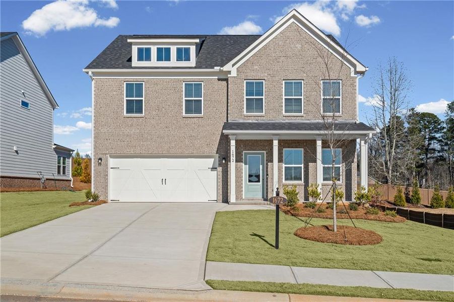 Front exterior of a new home in Berkeley Mill, Cumming, GA, highlighting curb appeal (Image 1). Front exterior of a new home in Berkeley Mill, Cumming, GA, highlighting curb appeal (Image 1).