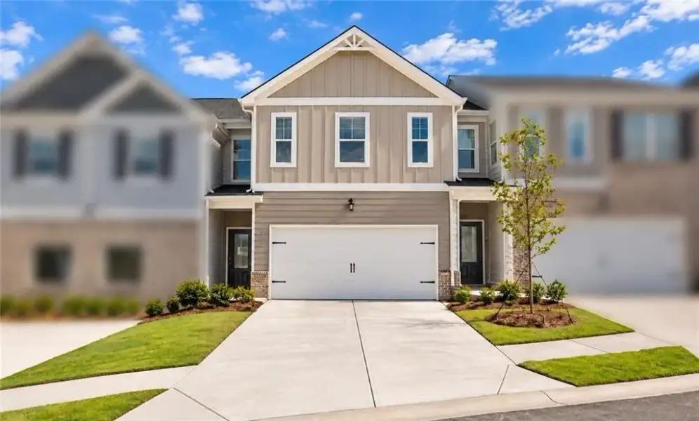 Front exterior of a new home in Cash's Crossing, Ellenwood, GA, highlighting curb appeal (Image 1). Front exterior of a new home in Cash's Crossing, Ellenwood, GA, highlighting curb appeal (Image 1).