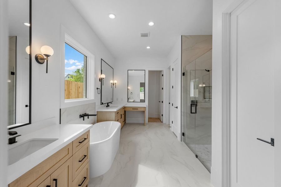 primary bathroom with 2 sinks, shower and tub