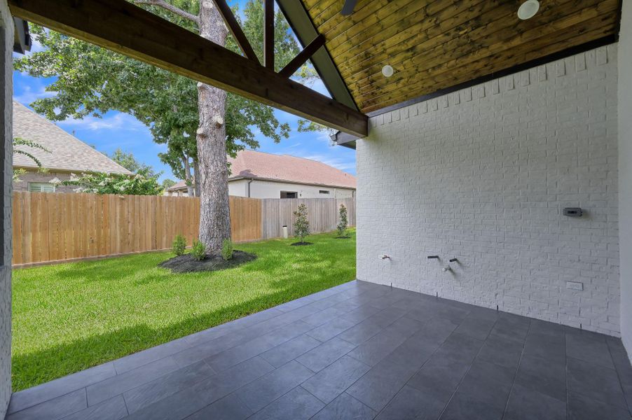 The spacious covered patio is perfect for outdoor dining and is already plumbed for a summer kitchen. The spacious covered patio is perfect for outdoor dining and is already plumbed for a summer kitchen.