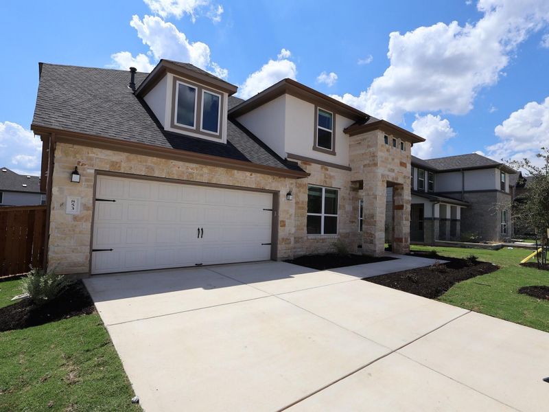 Front exterior of a new home in Edgewood, Leander, TX, highlighting curb appeal (Image 1).