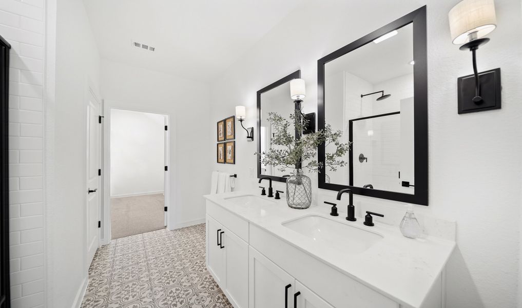 Primary bath with dual sinks and matte black fixtures throughout