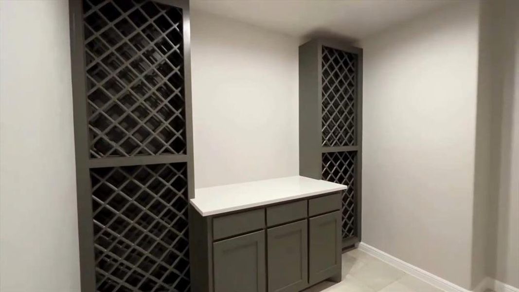Wine area featuring baseboards and light tile patterned floors