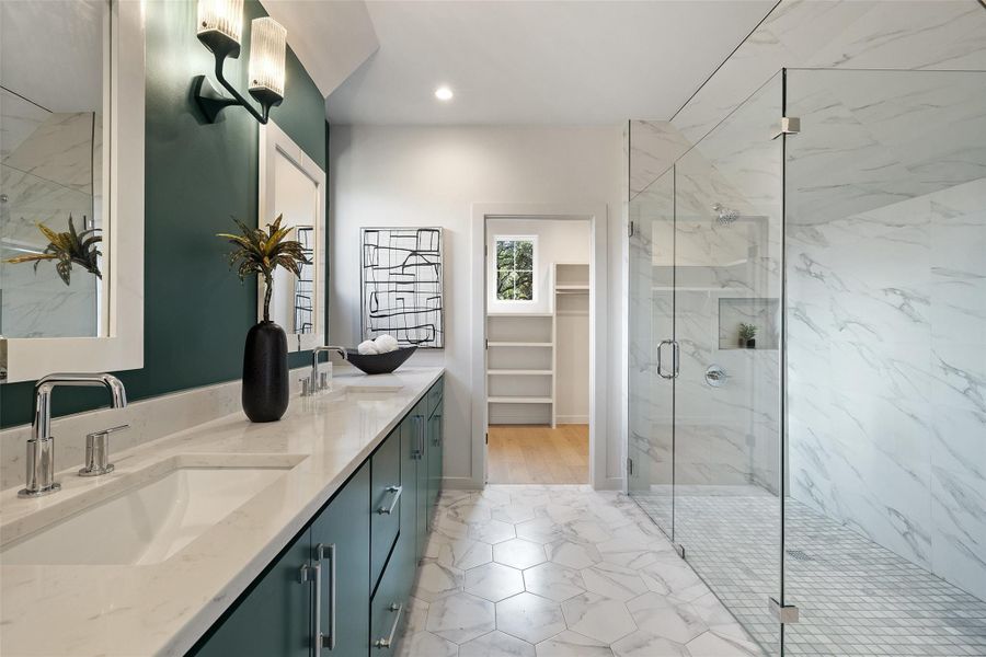 Bathroom featuring walk in shower and vanity