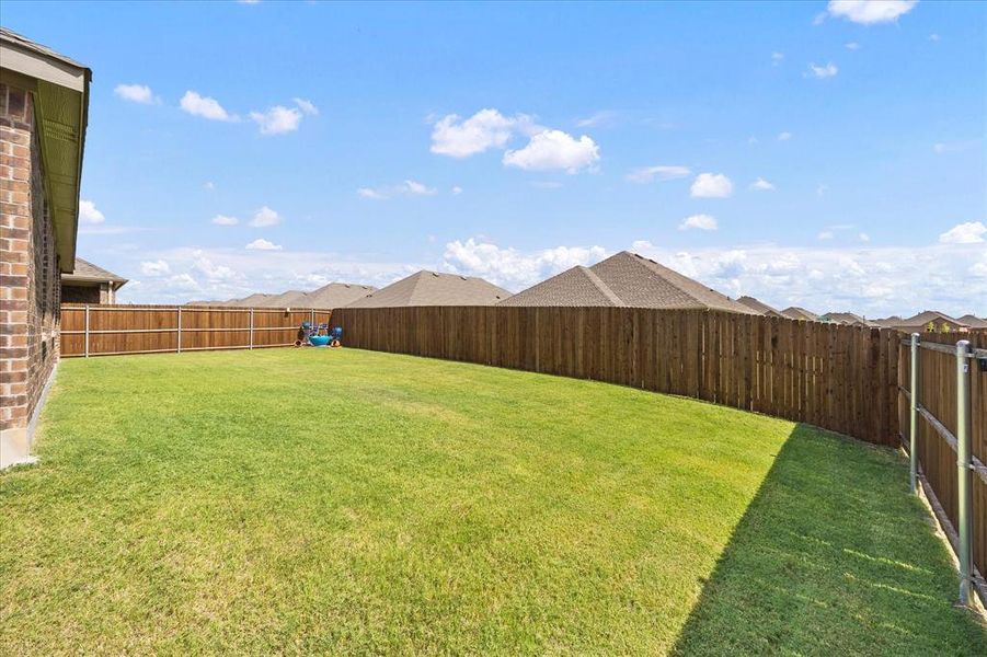 Fenced backyard has plenty of space for entertainment options Fenced backyard has plenty of space for entertainment options