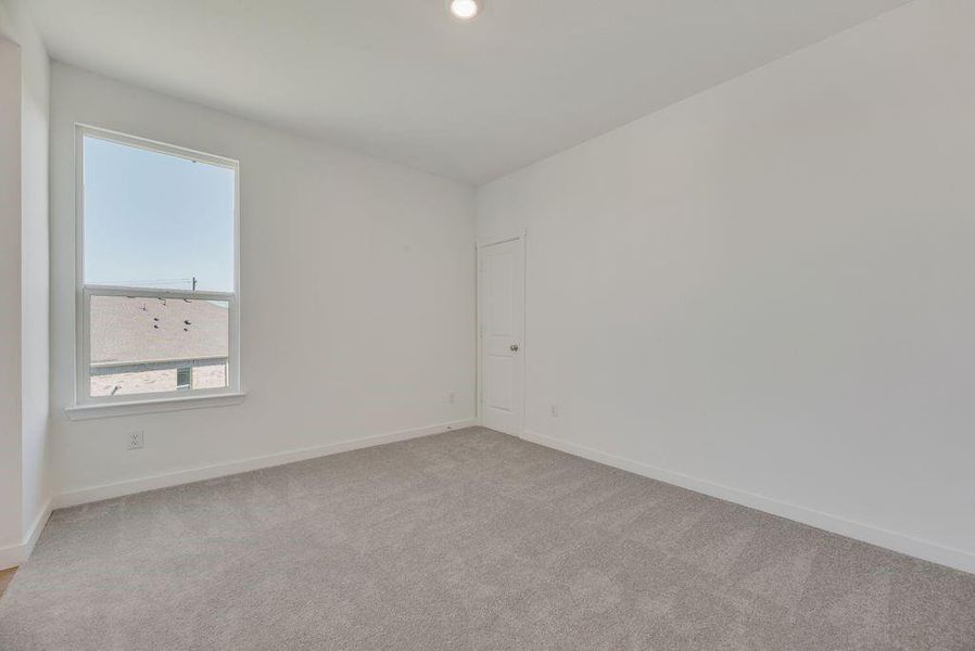 Empty room with carpet flooring and baseboards