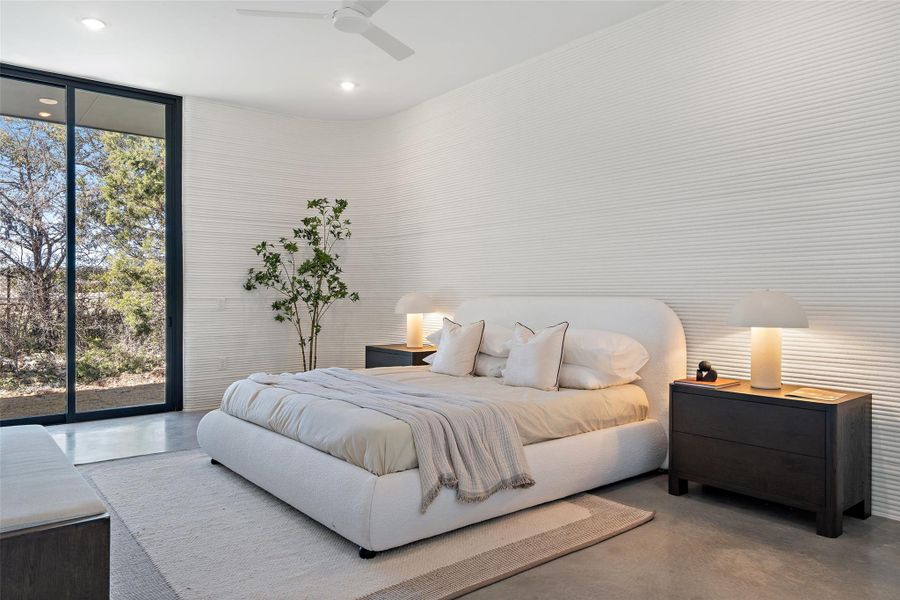 Bedroom featuring ceiling fan, concrete floors, floor to ceiling windows, and access to outside