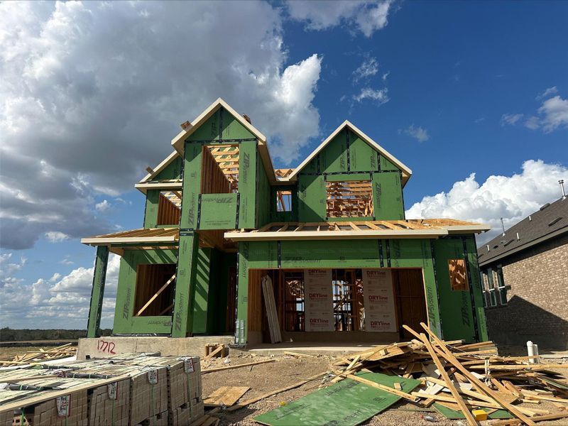 A new construction home with framing and sheathing visible, awaiting its final finishes. A new construction home with framing and sheathing visible, awaiting its final finishes.