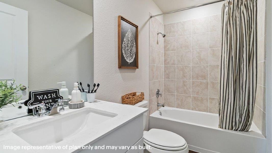 A well-appointed bathroom features a practical vanity with an integrated sink and a tiled shower-over-tub combination. A well-appointed bathroom features a practical vanity with an integrated sink and a tiled shower-over-tub combination.